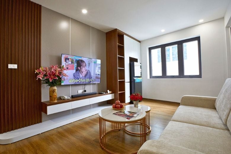 Living room with a wall-mounted television and dining table
